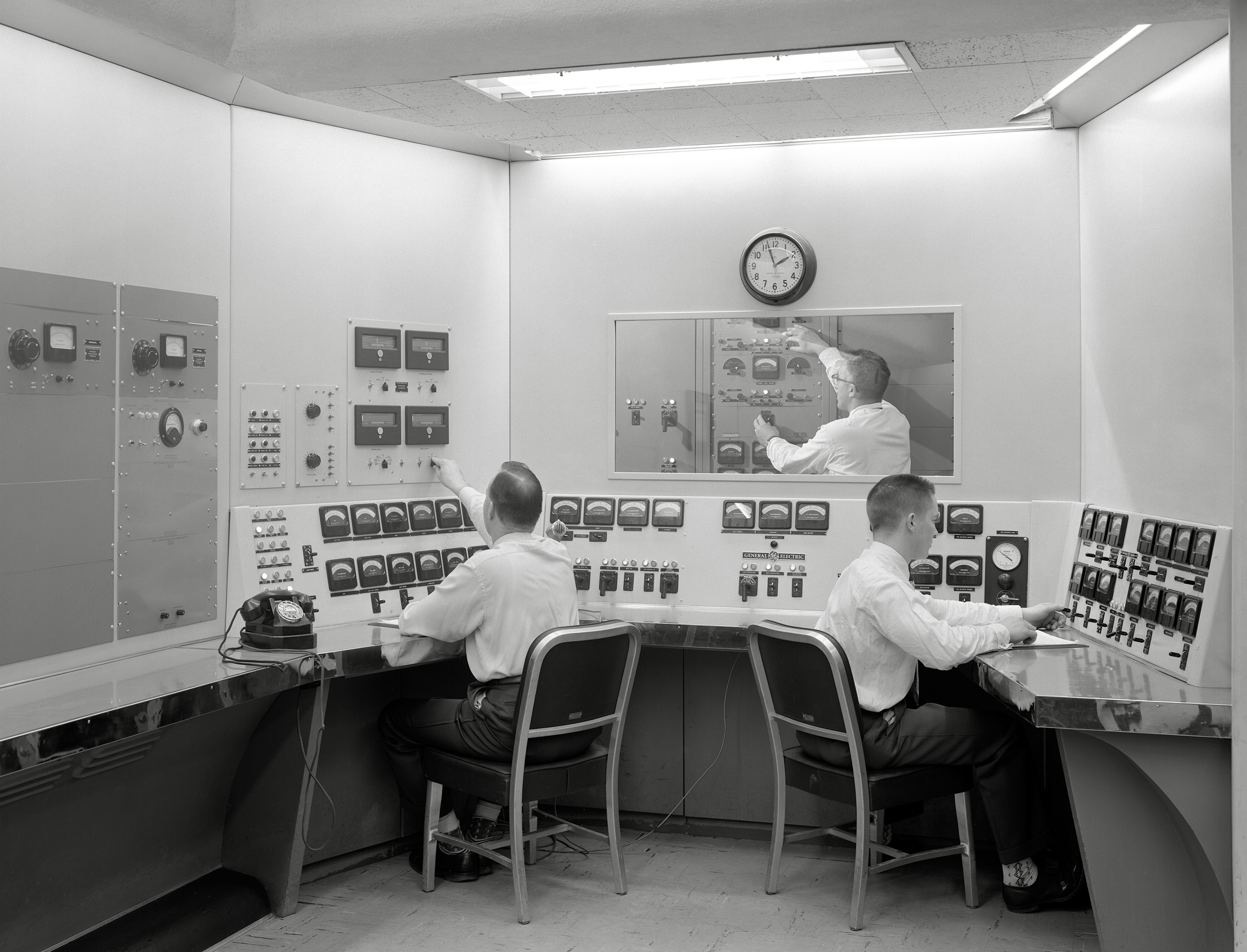 Three men in control room.