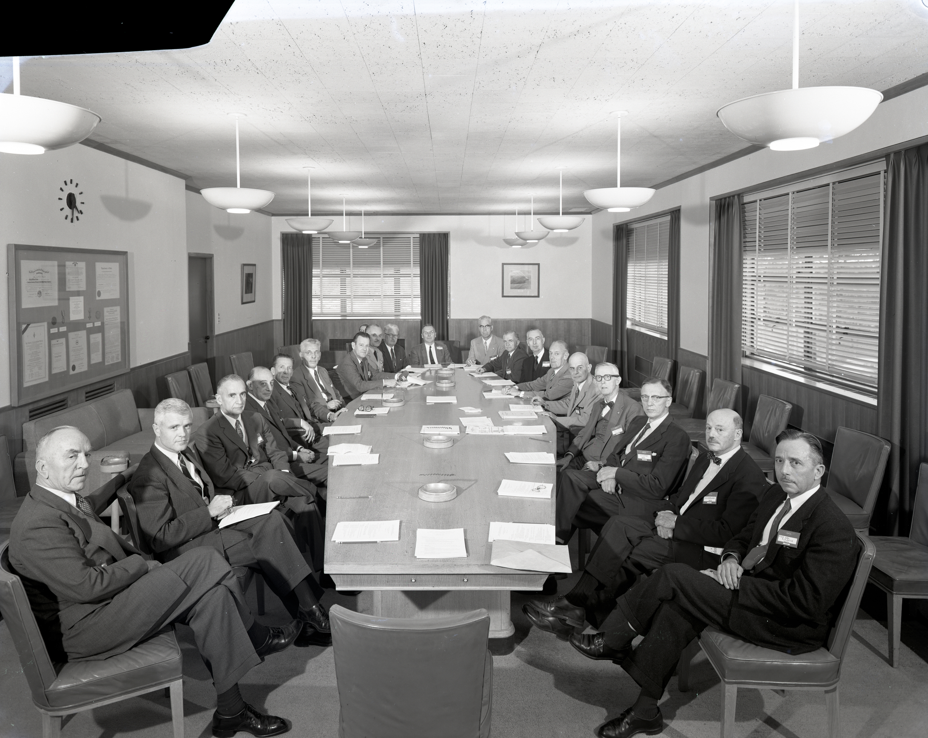 Group seated around table in conference room.