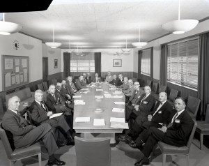 Group seated around table in conference room.