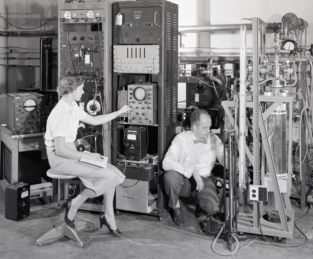 Woman and man with equipment.