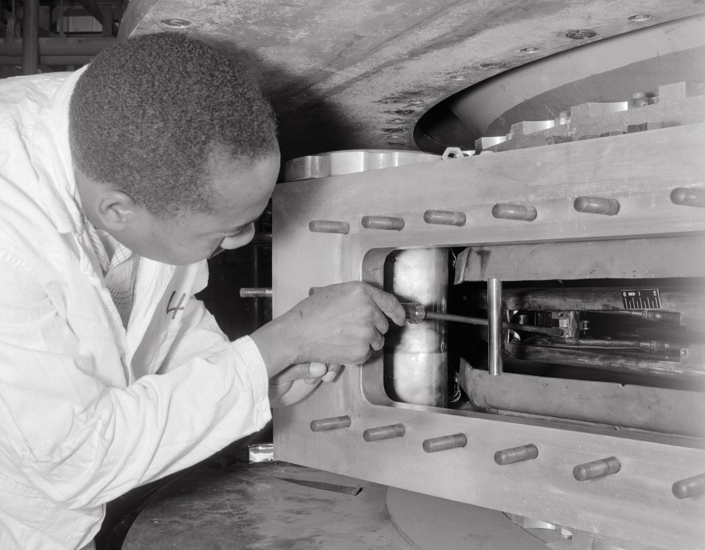 Man inspections cyclotron dees.