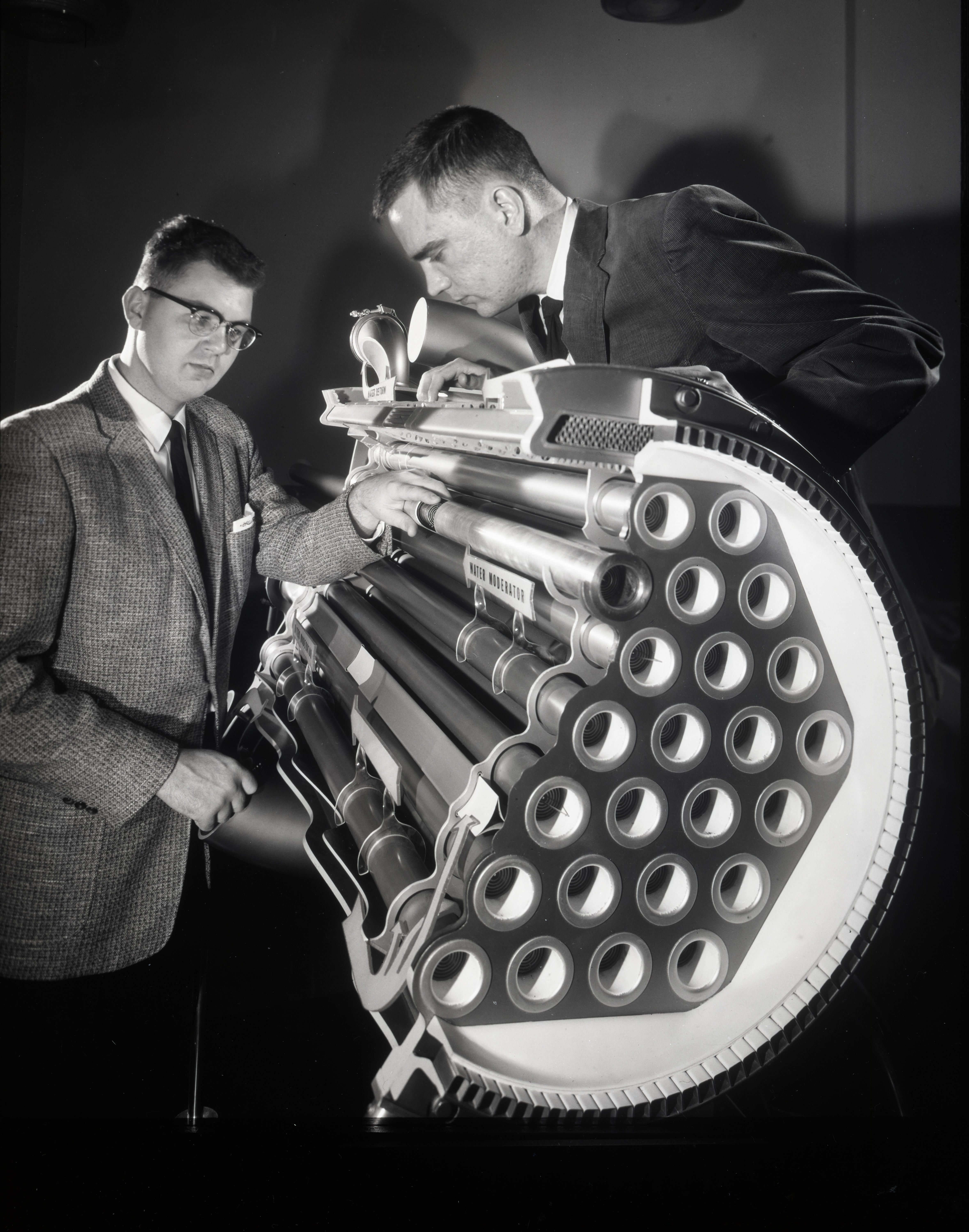 Men with nuclear rocket model.