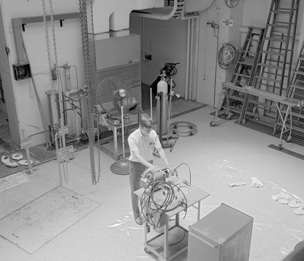 Man with rig in large room.