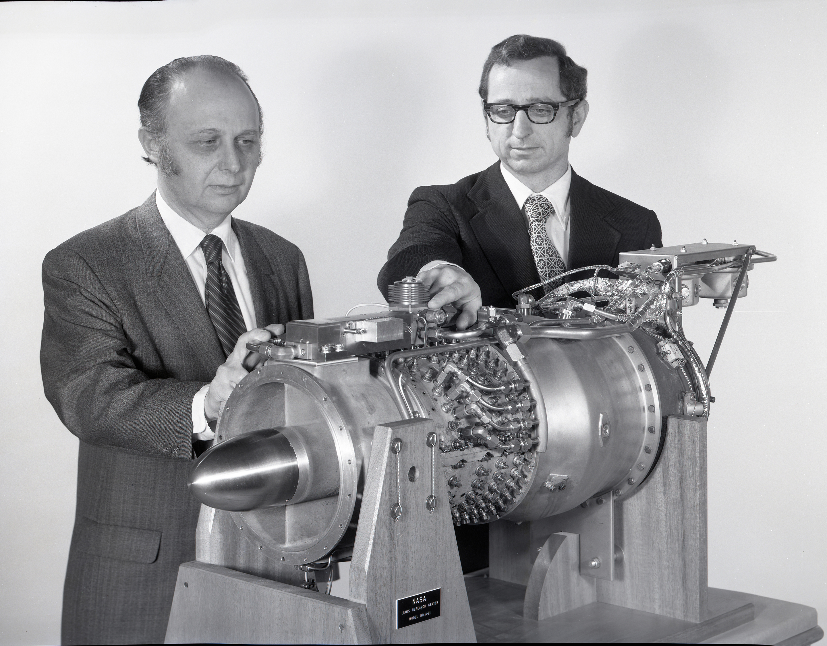 Two men looking at small engine.