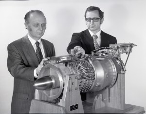 Two men looking at small engine.