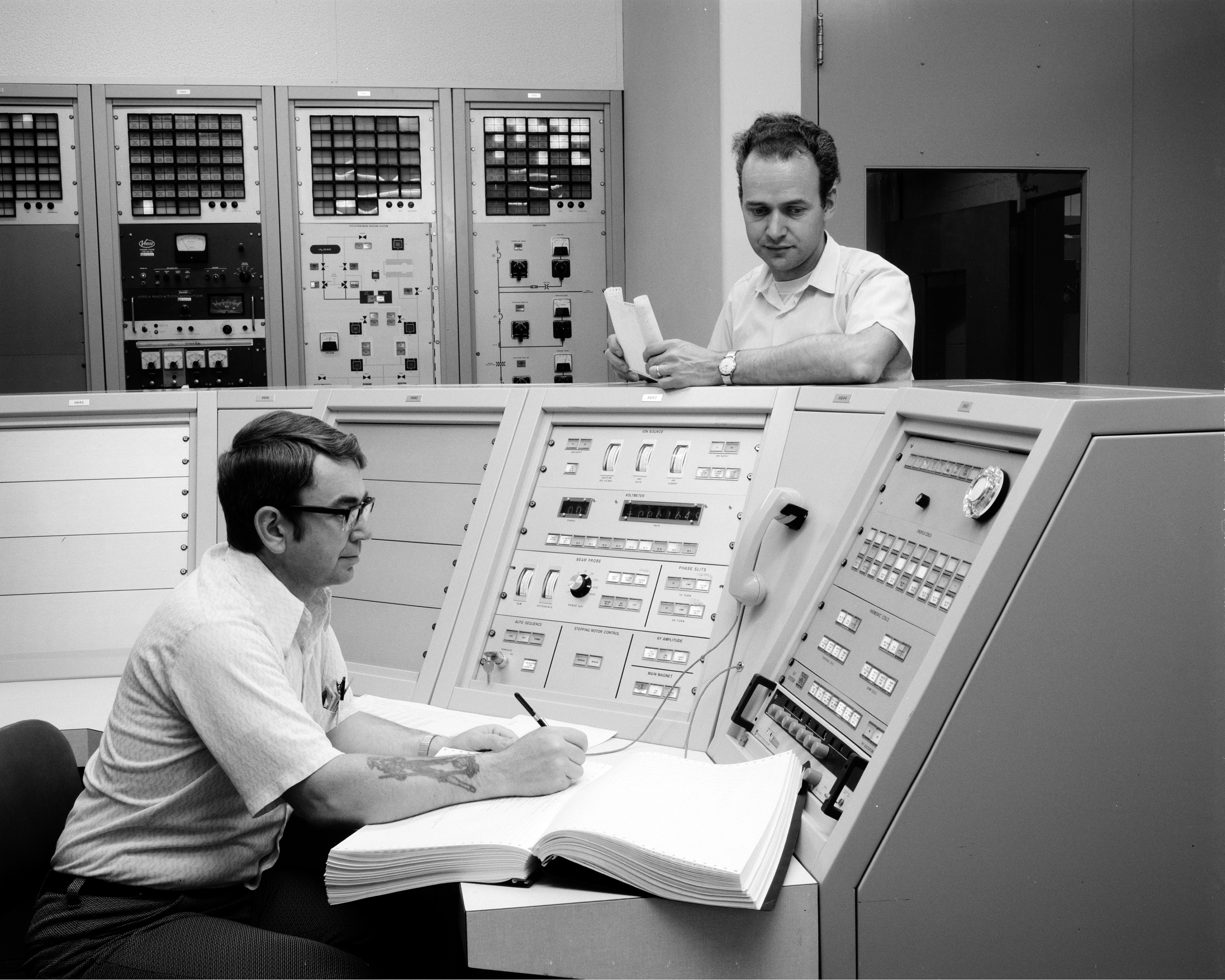 Men in control room.