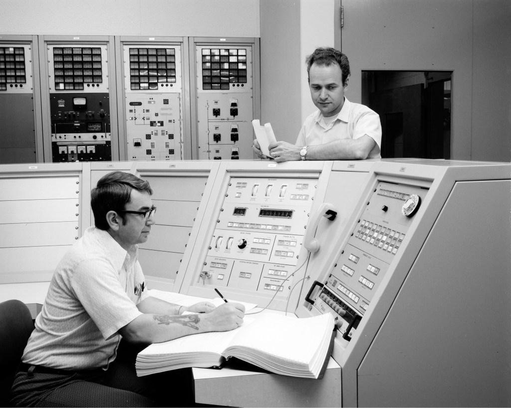 Men in control room.