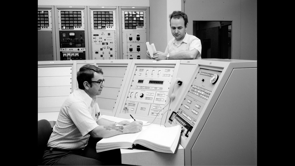 Men in control room.