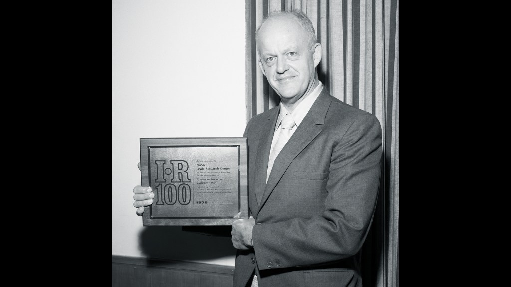 Man holding plaque.
