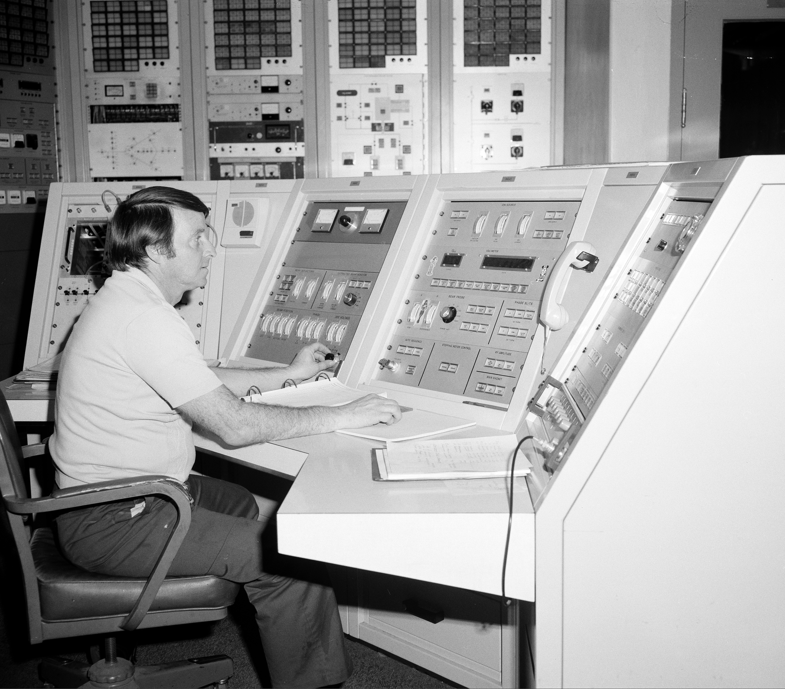 Man sitting at control panel.