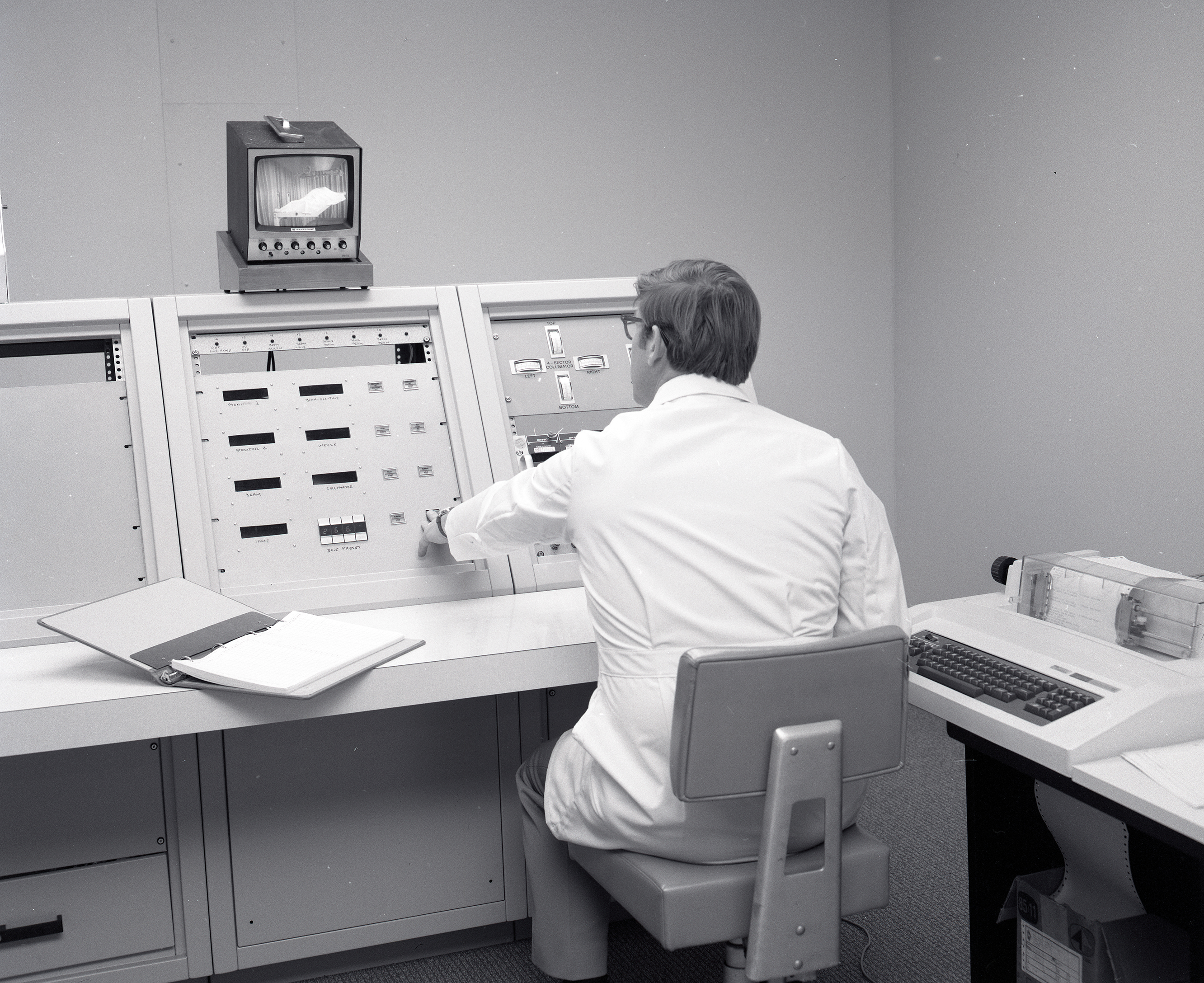 Doctor sitting at console.
