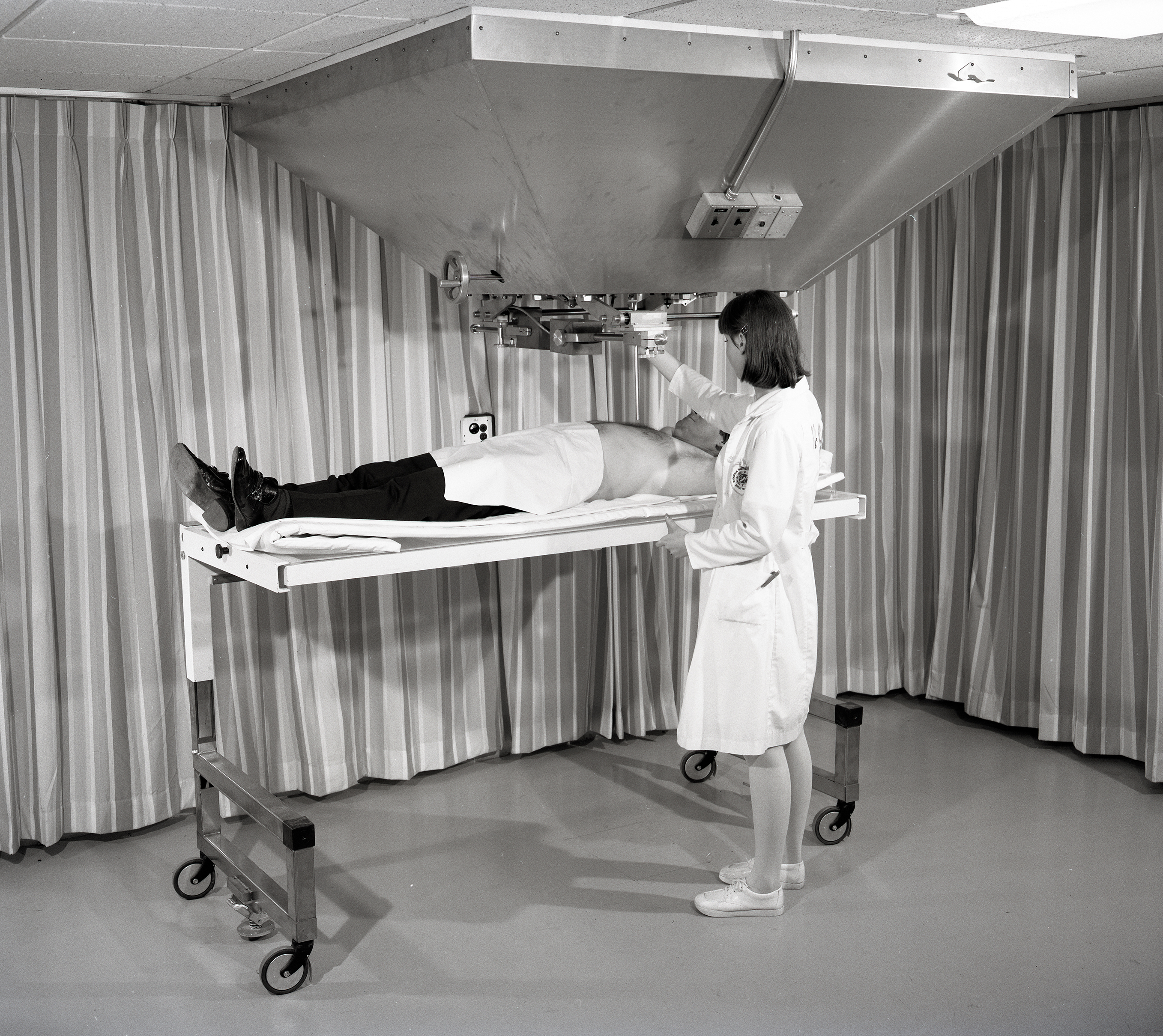 Nurse with patient on gurney.