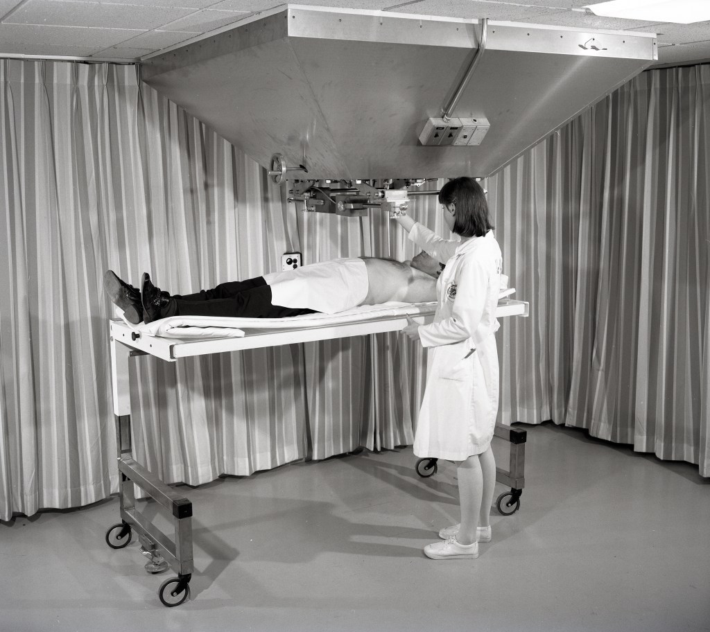 Nurse with patient on gurney.
