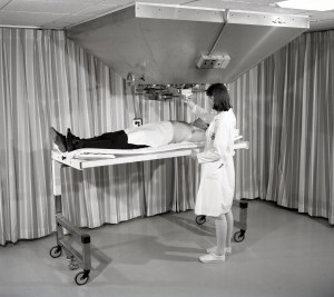 Nurse with patient on gurney.