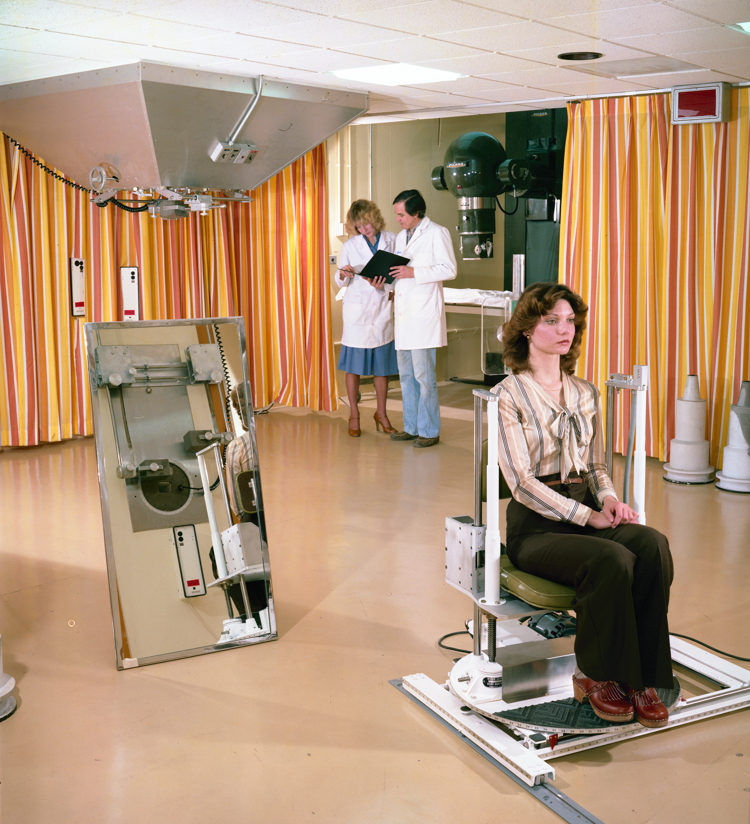 Medical staff and woman in therapy room.