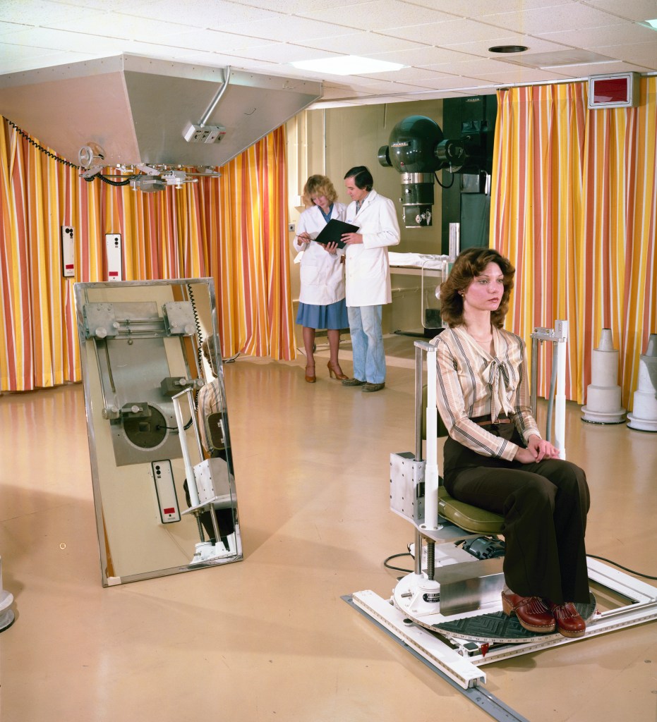 Medical staff and woman in therapy room.