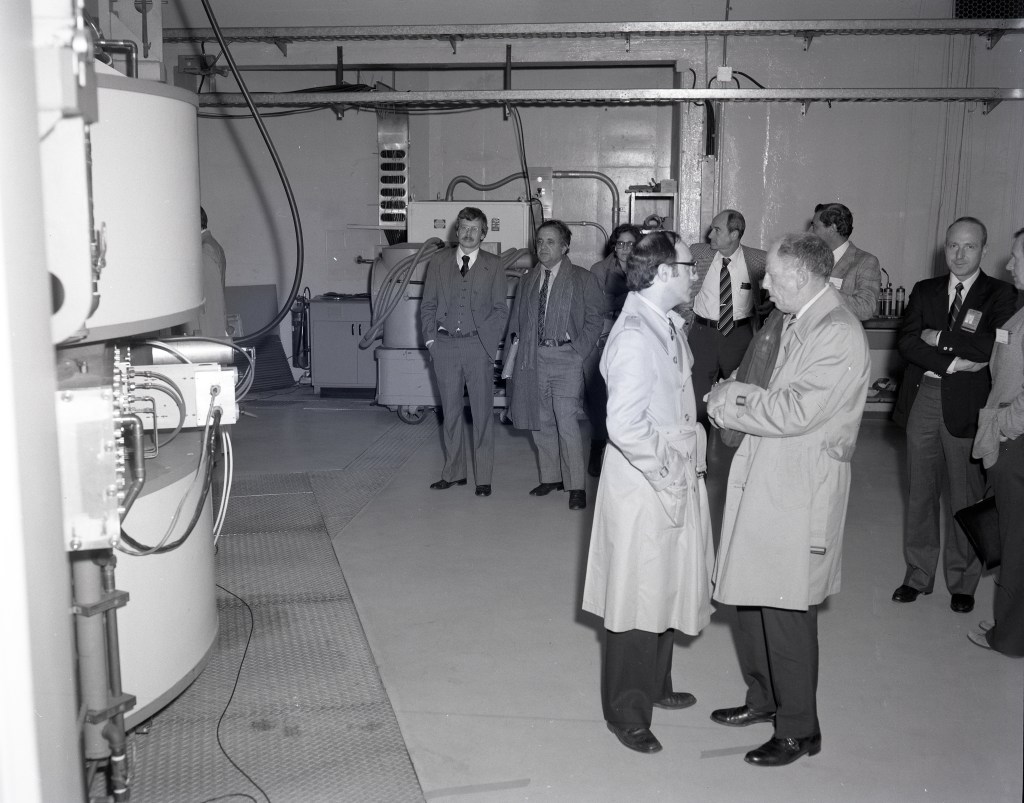 Men standing in control room.