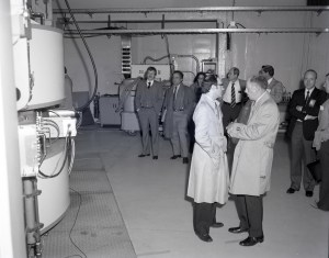Men standing in control room.