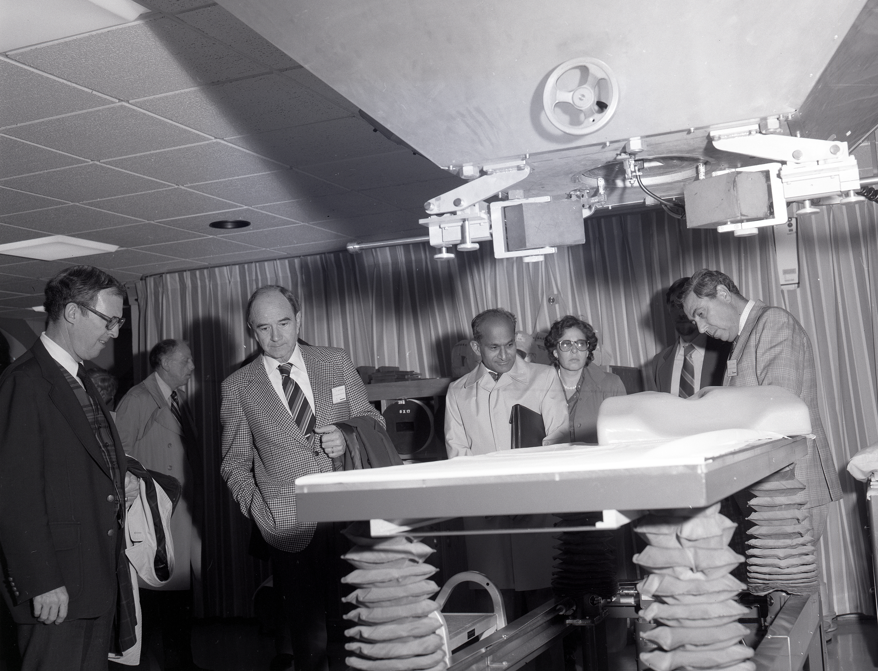Group inspecting gurney.
