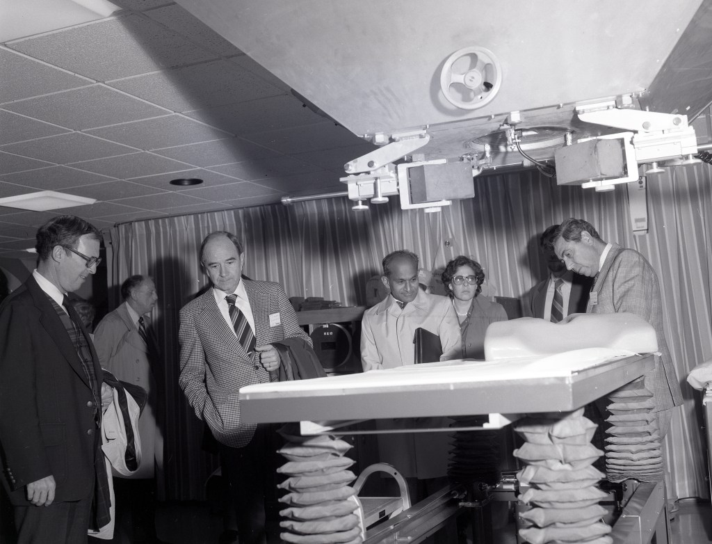 Group inspecting gurney.