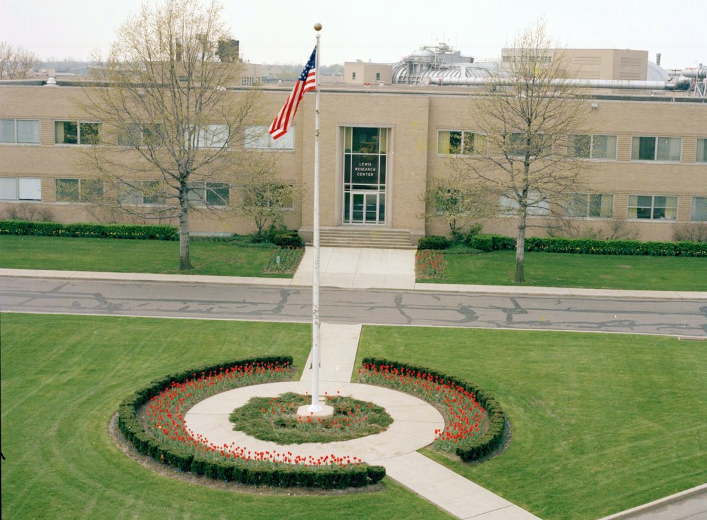 Flagpole in front of building.