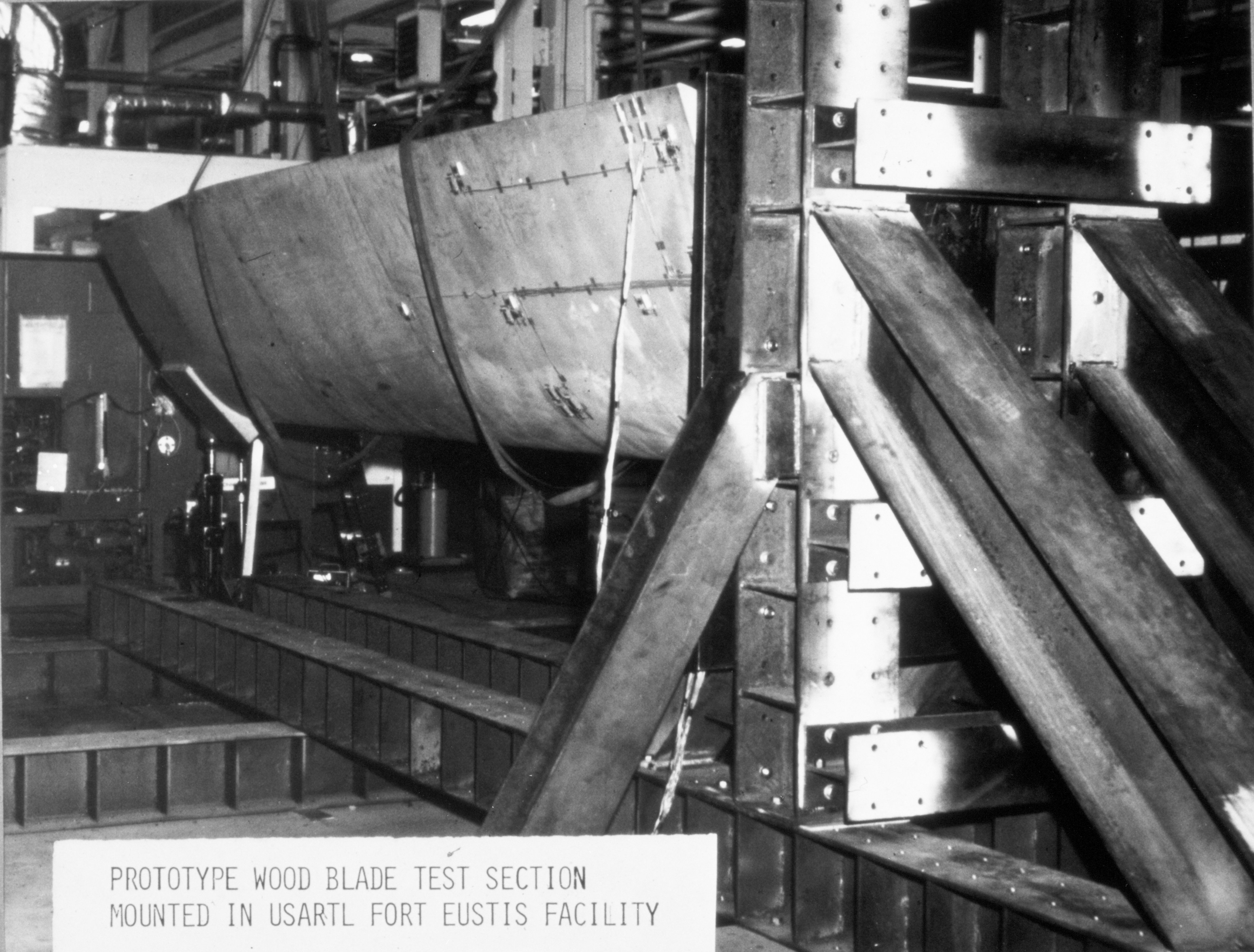 Wind turbine blade mounted in test stand.