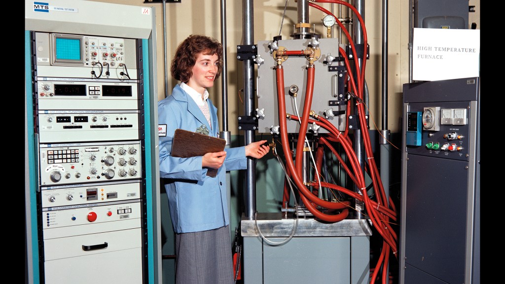 Woman examining test equipment.