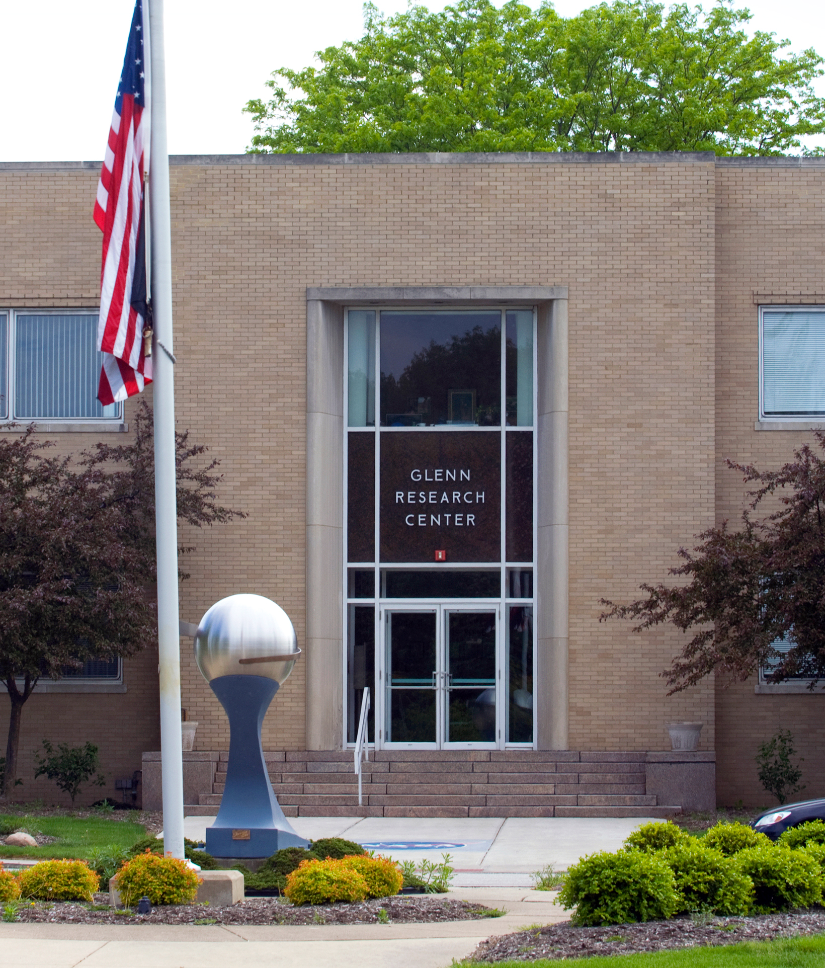 Entrance to building with flagpole in foreground.