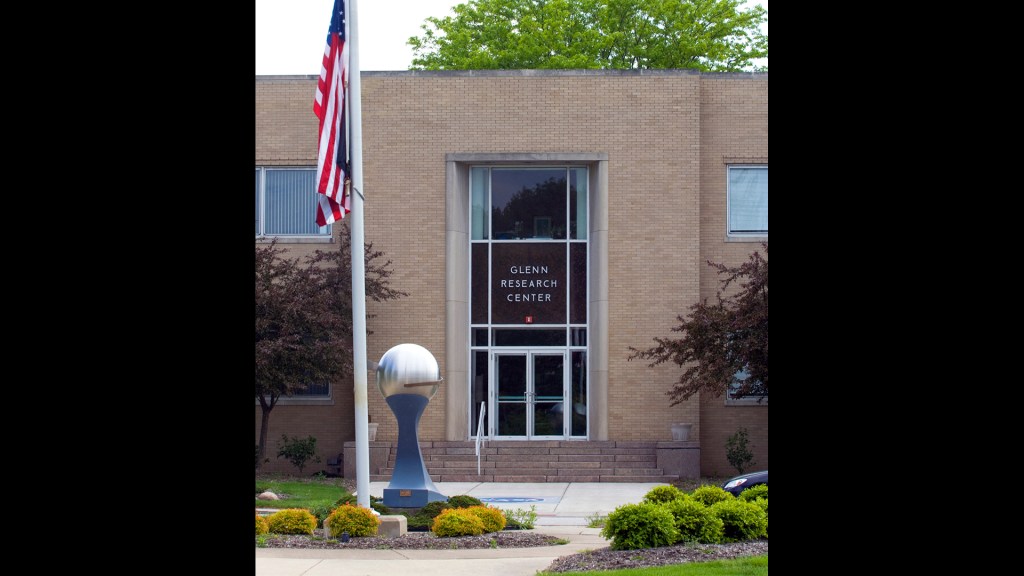 Entrance to building with flagpole in foreground.