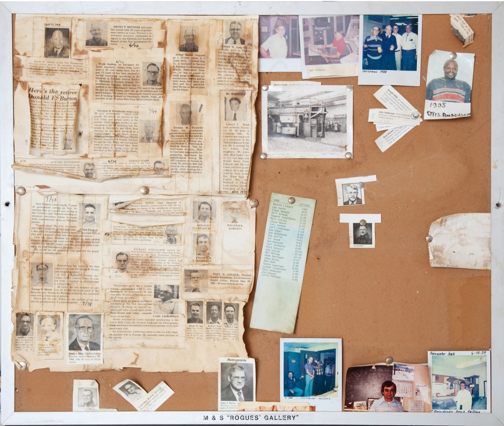 Bulletin board with articles and photographs.