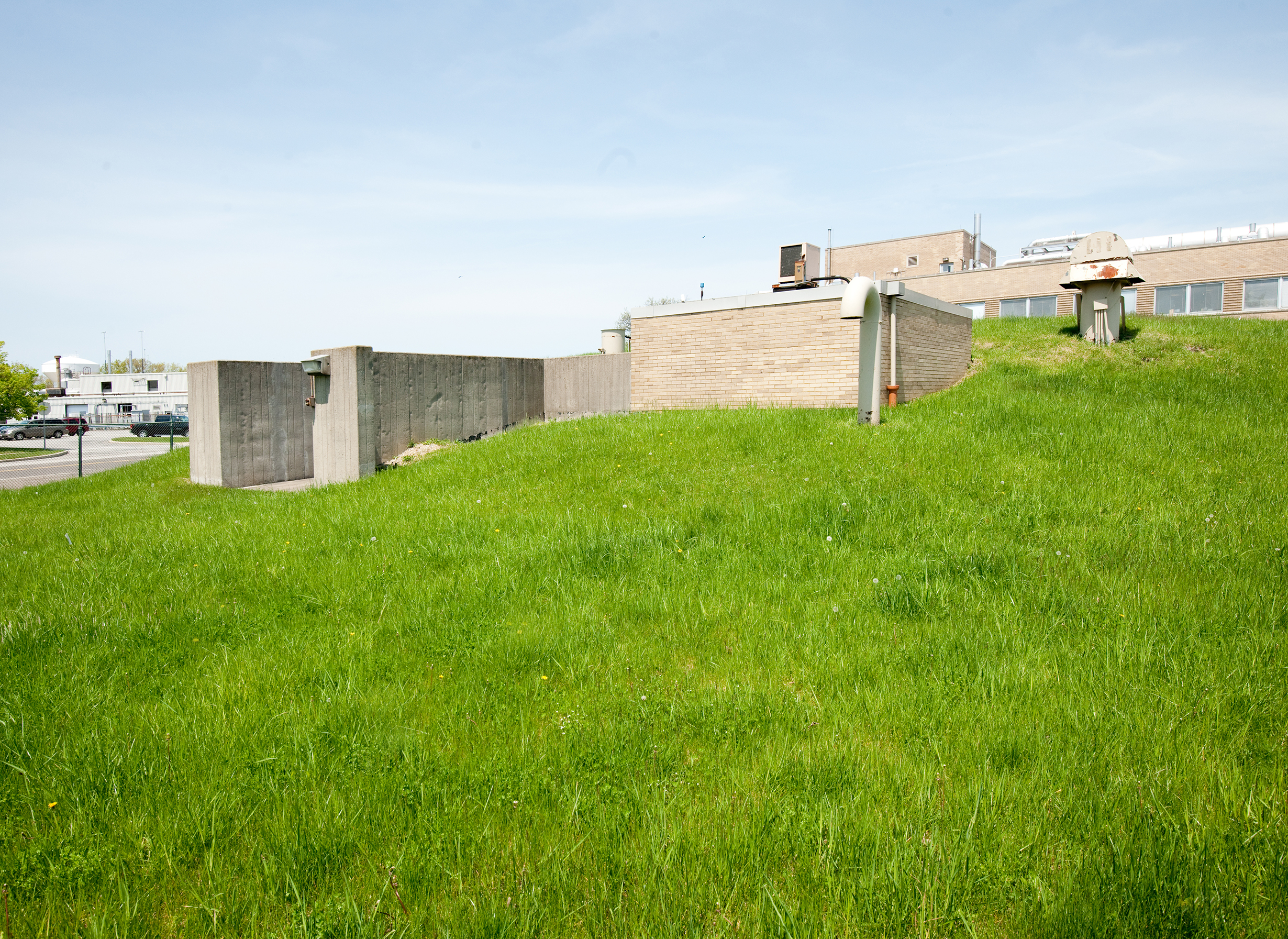 Grassy mound with building.