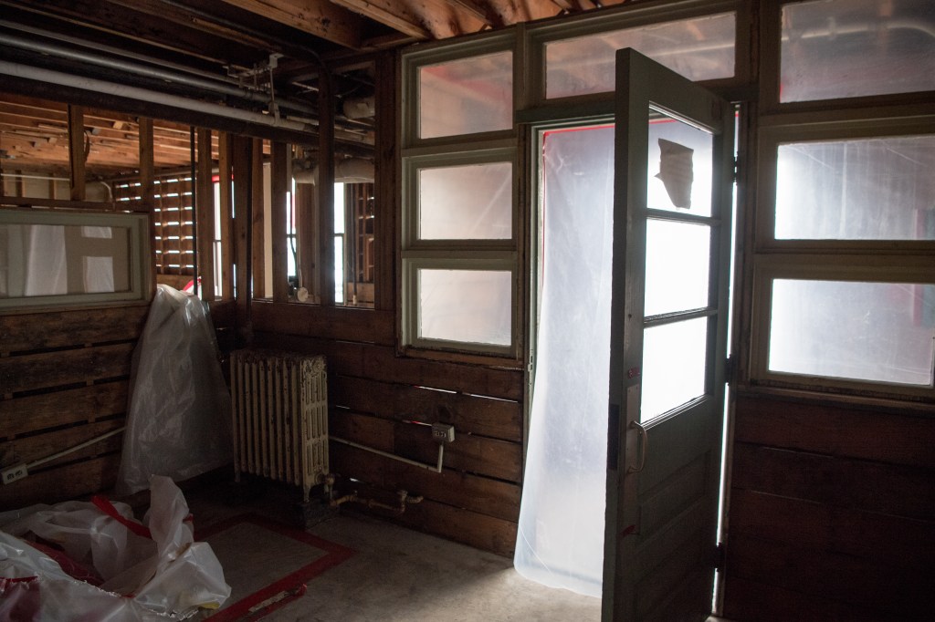 Open door in gutted room.