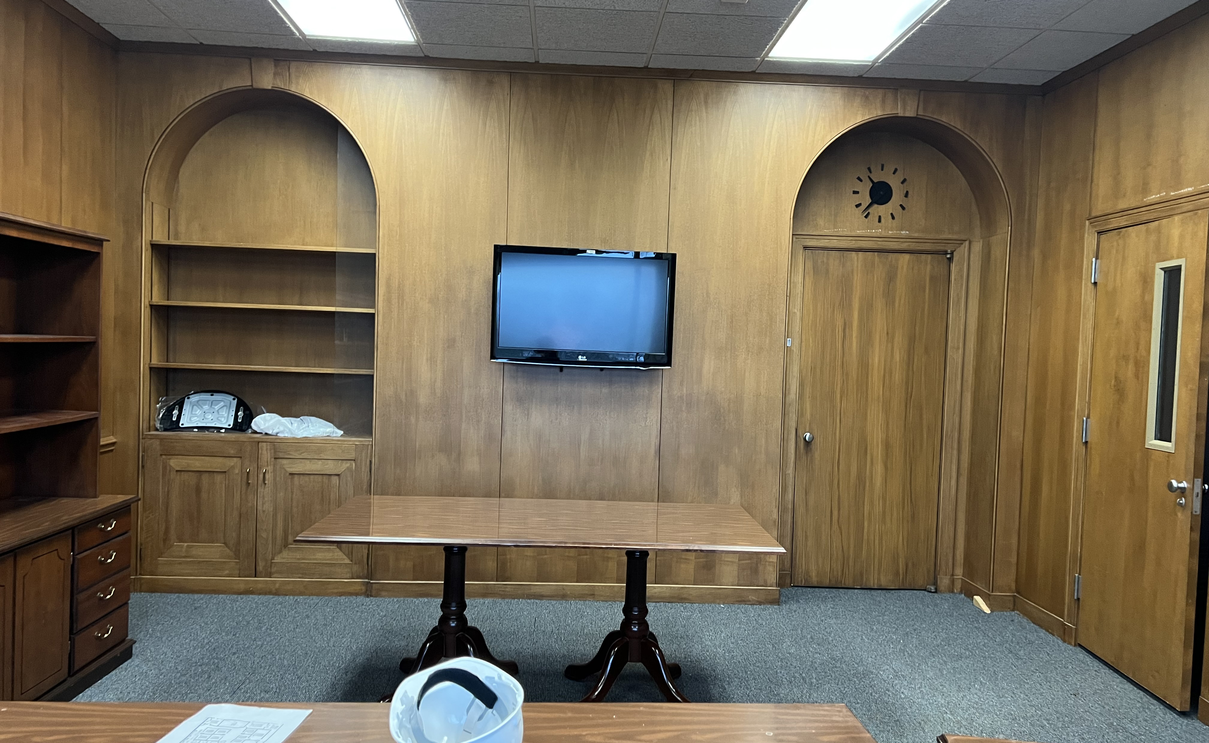 Wood-paneled office room.