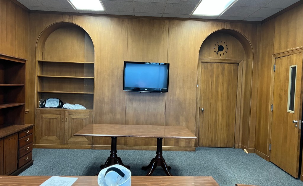 Wood-paneled office room.