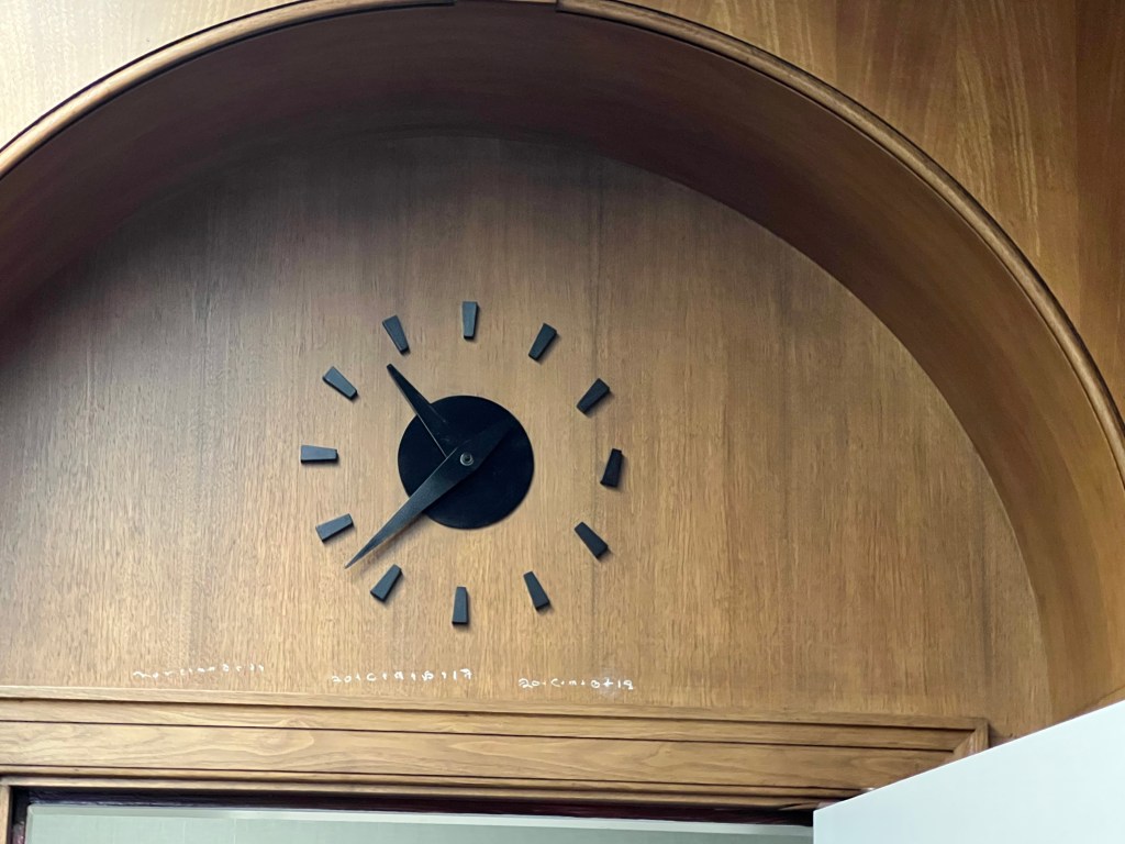 Clock above doorway.
