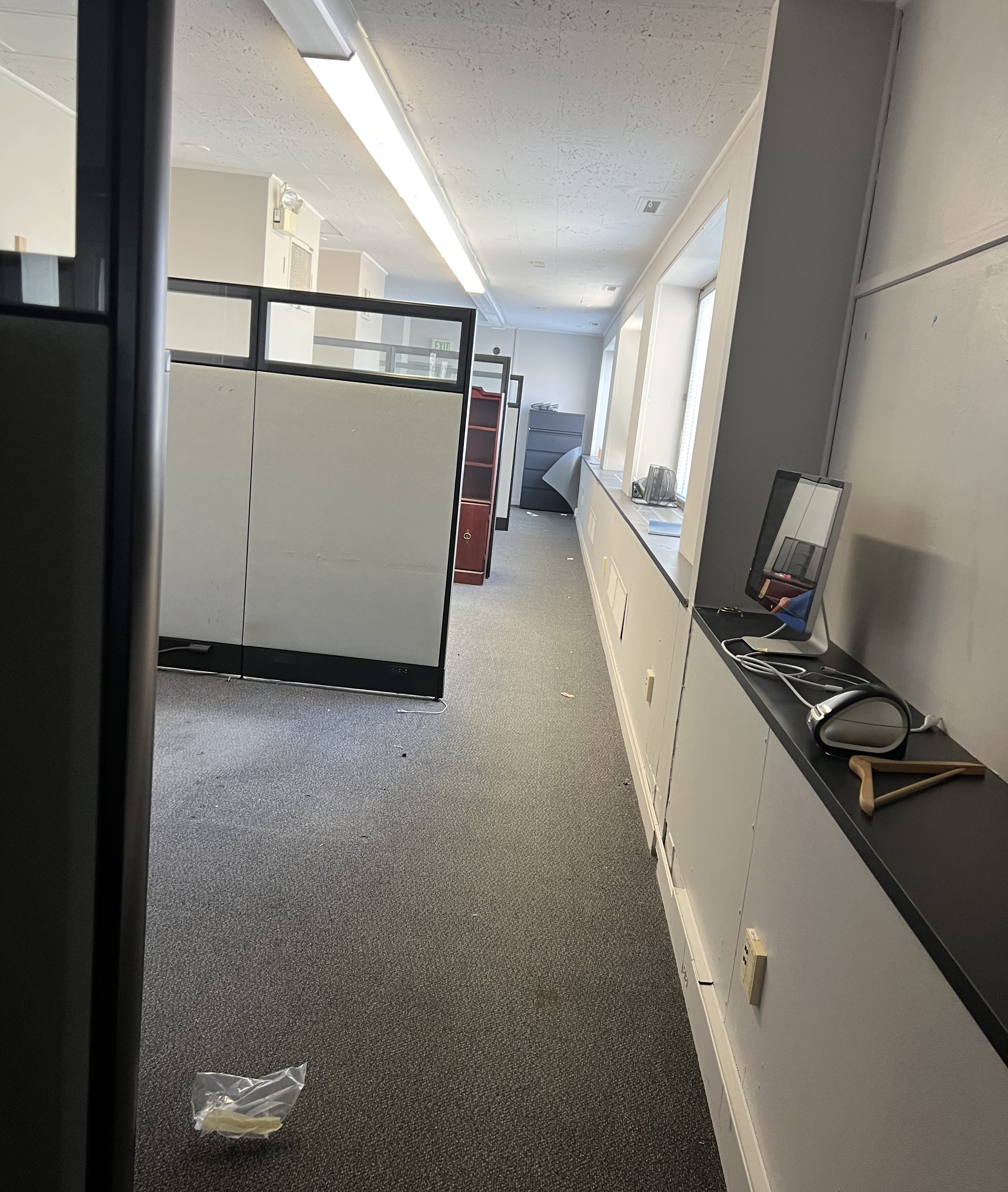 Cubicles in long narrow room.