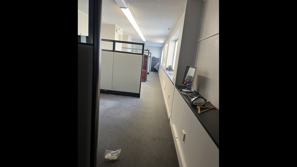 Cubicles in long narrow room.