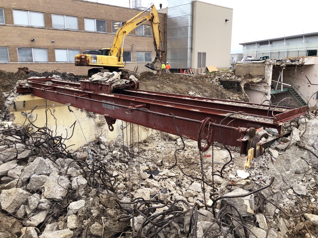 Rubble on ground with crane in background.