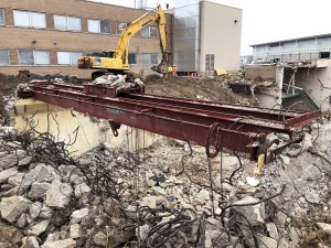 Rubble on ground with crane in background.