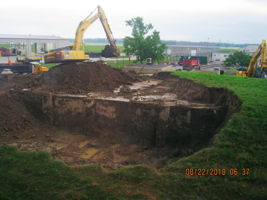 Backhoe removes earth.