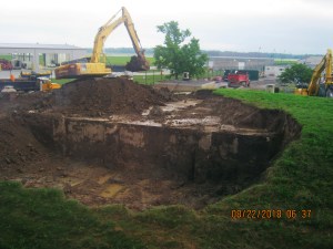 Backhoe removes earth.