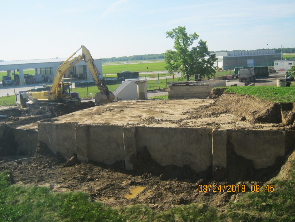 Backhoe removes earth.