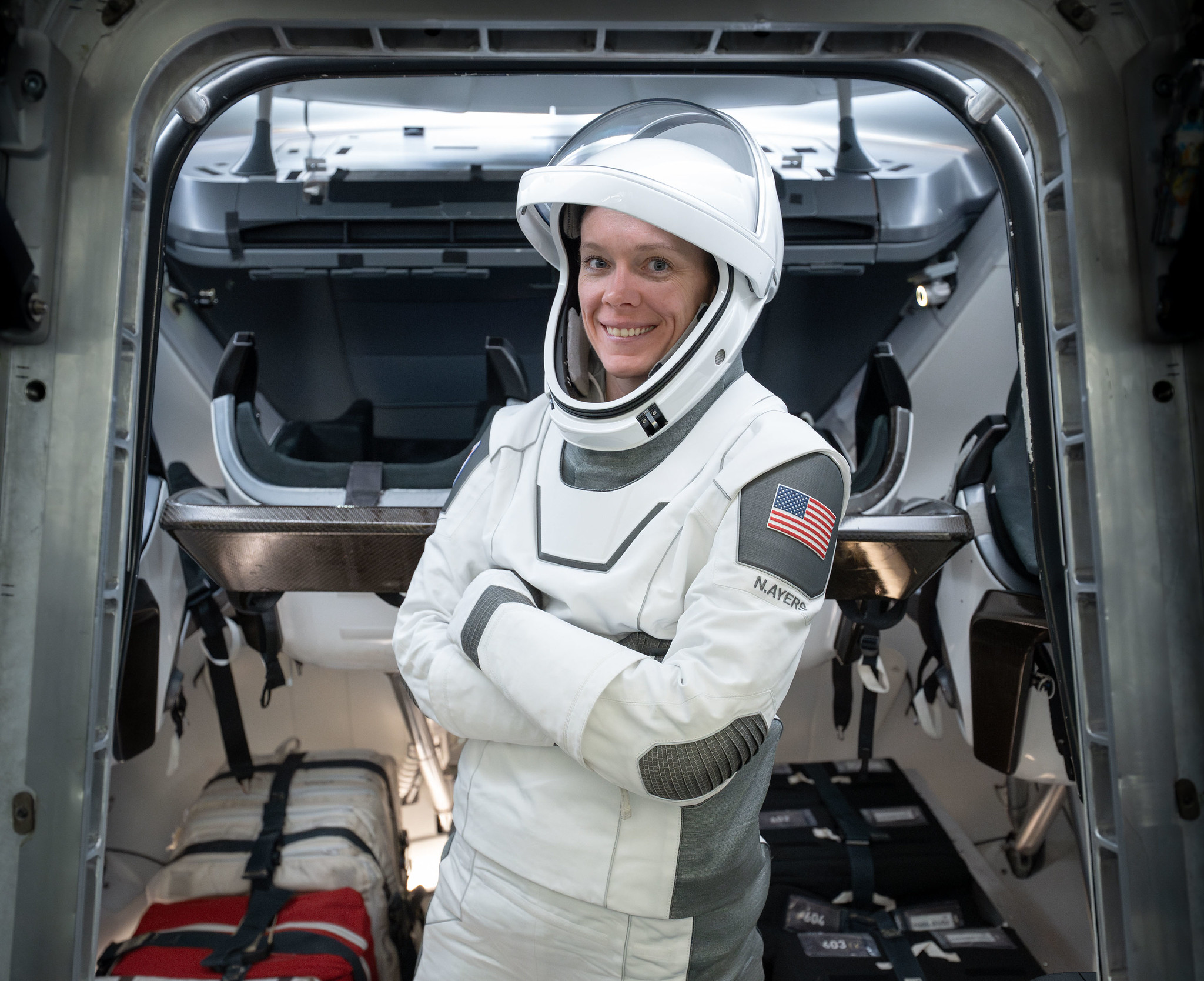 NASA astronaut and Pilot for NASA’s SpaceX Crew-10 mission Nichole Ayers is pictured inside a mockup of a Dragon cockpit at the company's facilities in Hawthorne, California. 