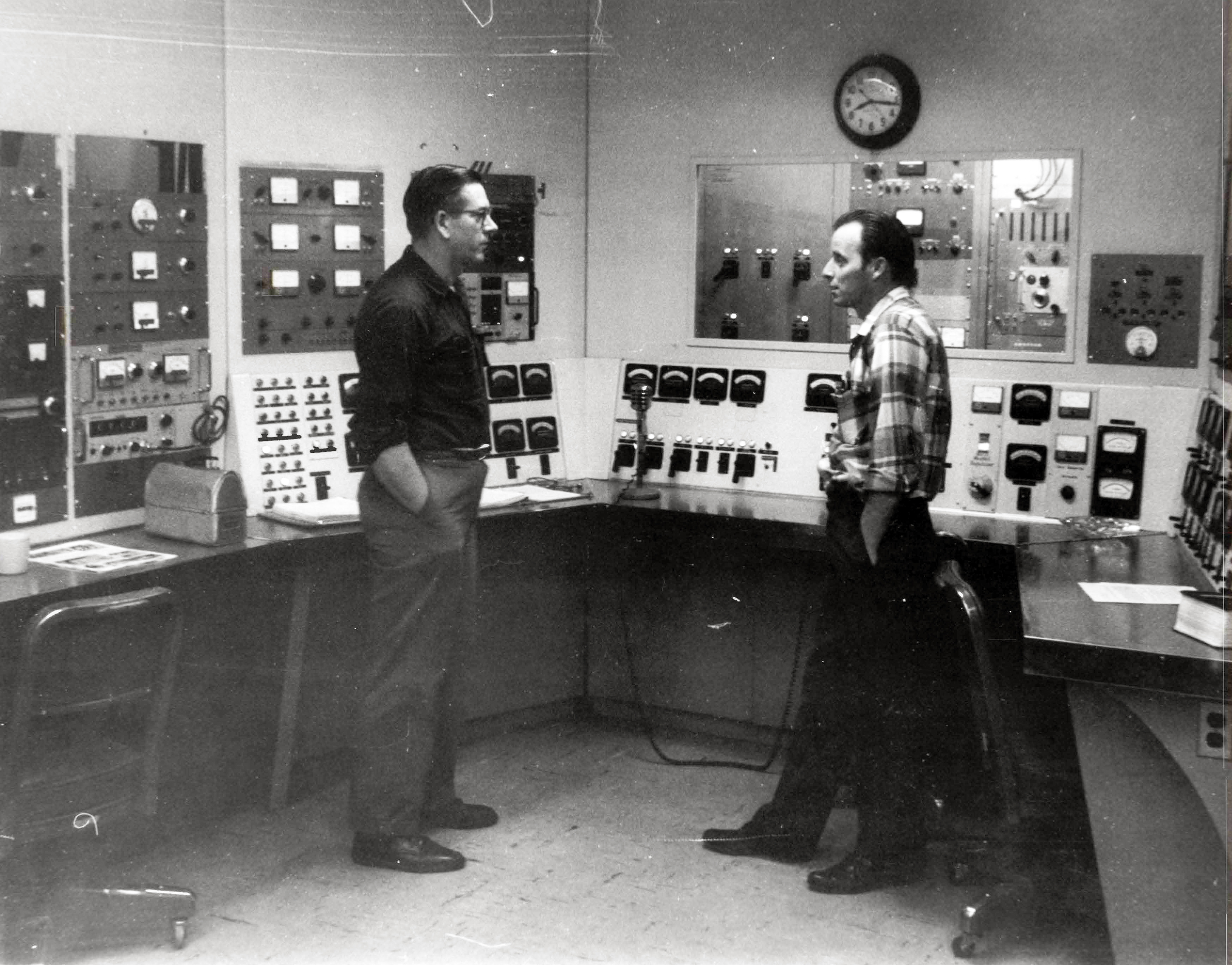 Men in control room.