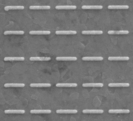 A grayscale image showing five rows of evenly spaced, horizontal, rectangular bars on a flat, textured background. The bars appear raised and have a metallic or matte finish.