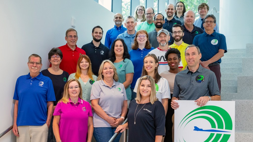 Quesst team group photo out at NASA Langley standing on a flight of stairs.