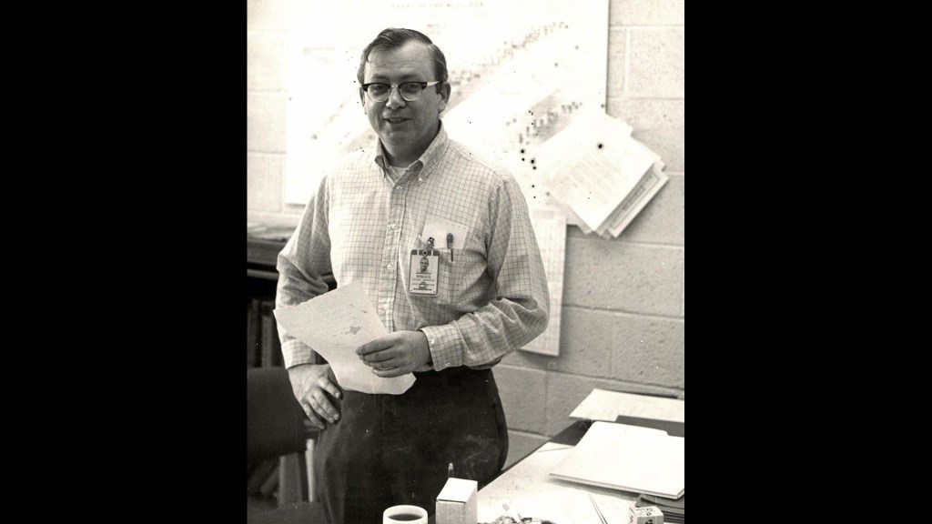Man standing in office.
