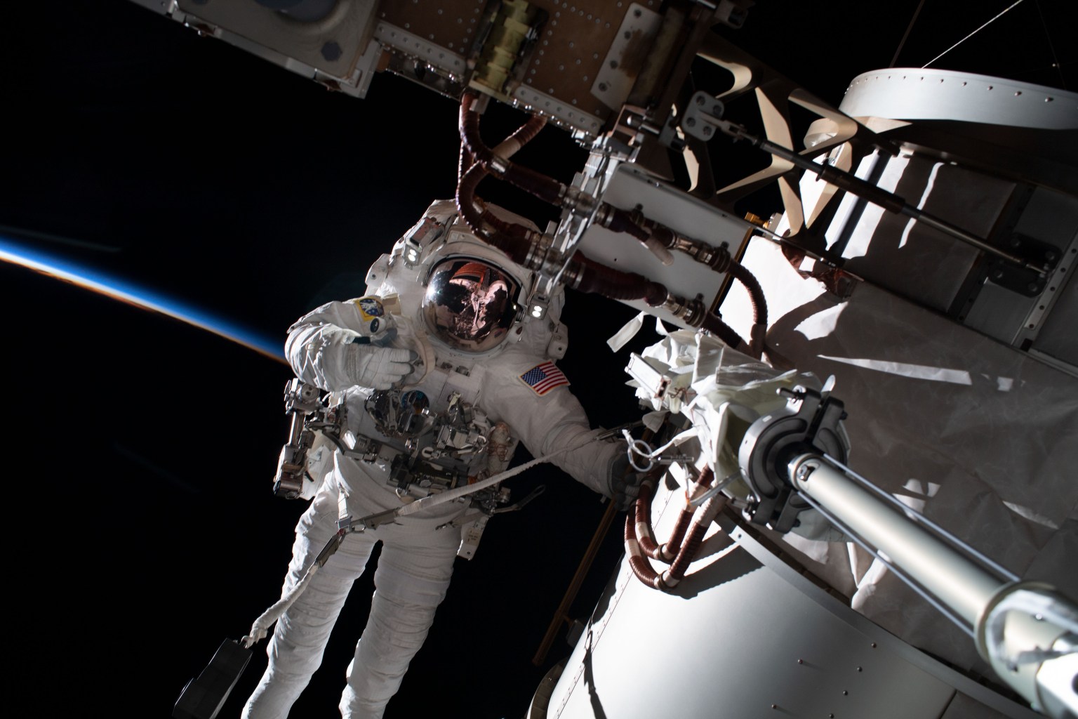 NASA astronaut and Expedition 68 Flight Engineer Frank Rubio is pictured during a spacewalk tethered to the International Space Station's starboard truss structure. Behind Rubio, the last rays of an orbital sunset penetrate Earth's thin atmosphere as the space station flew 258 miles above the African nation of Algeria.