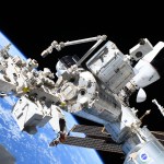 This photograph from NASA spacewalker Nichole Ayers looks to the forward portion of the International Space Station and highlights the Kibo laboratory module with the Japanese robotic arm, the SpaceX Dragon cargo spacecraft docked to the Harmony module's space-facing port, and the partially obscured SpaceX Dragon crew spacecraft docked to Harmony's forward port. The International Space Station was orbiting 260 miles above the Pacific Ocean east of the Hawaiian island chain.