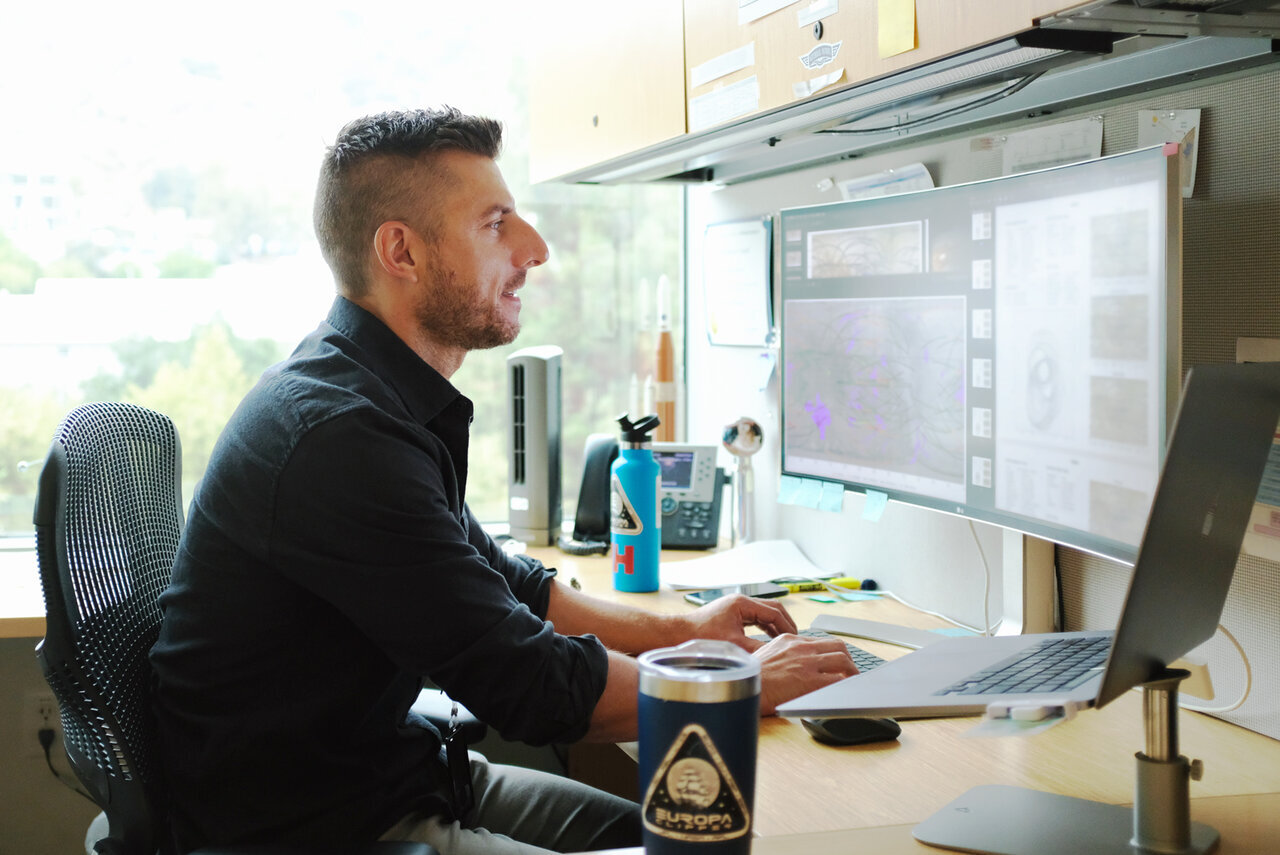 Brent Buffington, Europa Clipper's mission design manager, working on the spacecraft's trajectory in his office